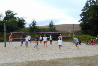Children and youth are playing beach volleyball