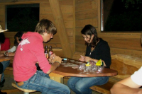 The youth are having a game of cards in the youth pavillon