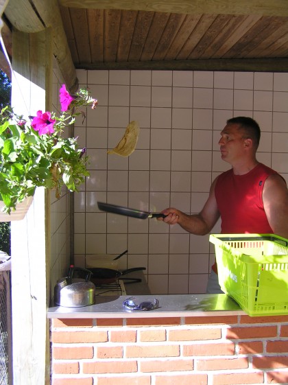 Pan cakes in the air in the camping kitchen